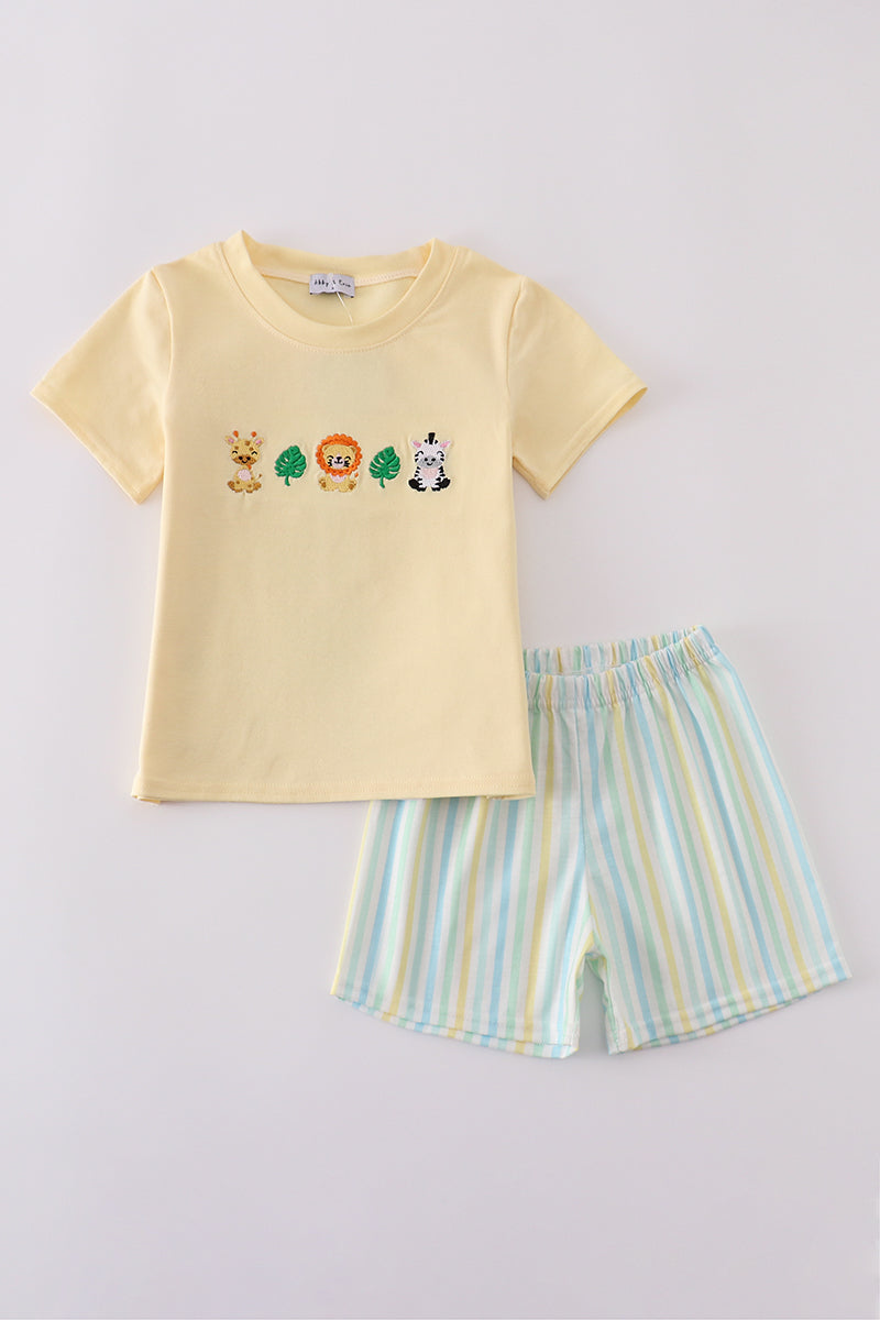 Yellow shirt with giraffe, lion, zebra, and 2 leaves and white, yellow, blue, and green striped shorts