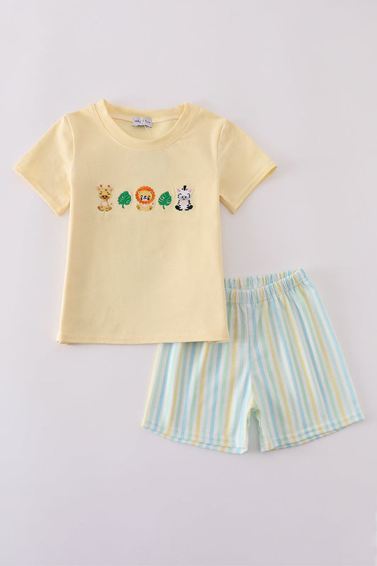Yellow shirt with giraffe, lion, zebra, and 2 leaves and white, yellow, blue, and green striped shorts