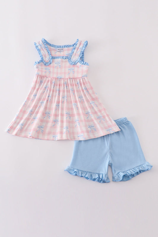 Pink gingham top with blue bows and blue ruffle trip and blue ruffle shorts