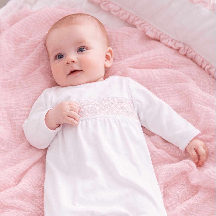 White Smocked Footie – Pink Trim