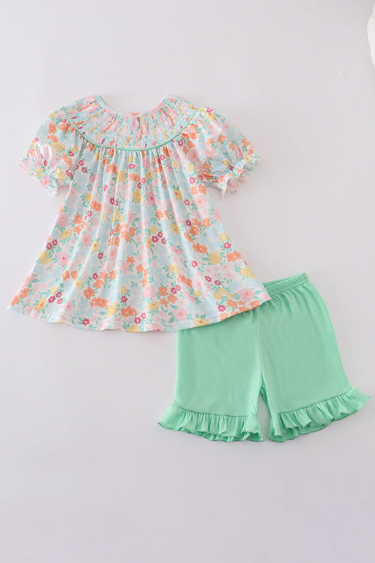 Smocked top with spring flowers and green ruffled shorts
